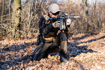 Male from private military company with rifle in the forest