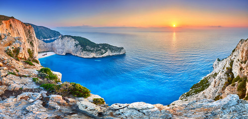Fototapeta na wymiar Navagio Beach with shipwreck view on Zakynthos island, Greece. Incredibly romantic sunrise on Zakinthos. Amazing sunset view with multicolored clouds. Island of lovers. Doors to heaven