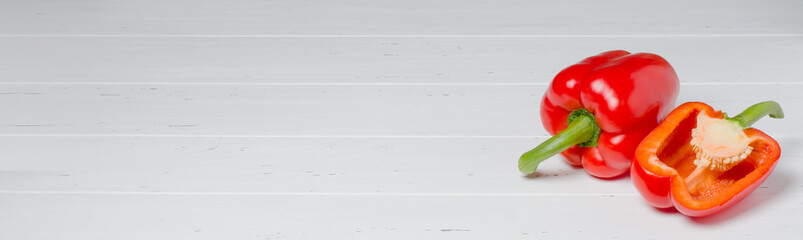 Red pepper on a white wooden background. Copy space