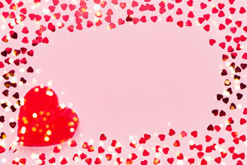 Valentines Day card. Lollipop candy heart shape with confetti on pink background. Copy space, top view.
