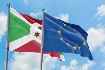 European Union and Burundi flags waving in the wind against white cloudy blue sky together. Diplomacy concept, international relations.