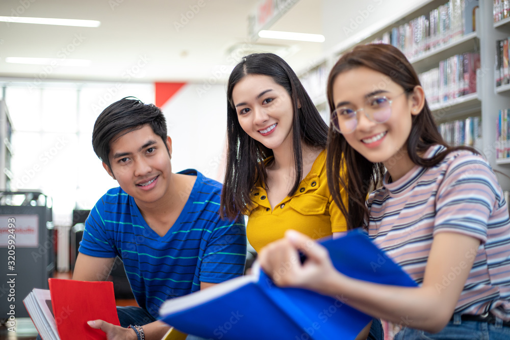 Poster group asian students smile and reading book and using notebook for helps to share ideas in the work 
