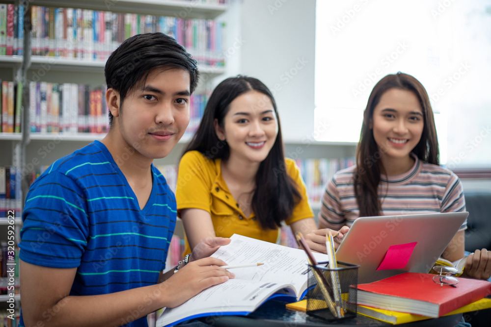 Poster group asian students smile and reading book and using notebook for helps to share ideas in the work 