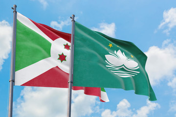 Macao and Burundi flags waving in the wind against white cloudy blue sky together. Diplomacy concept, international relations.