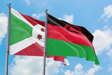 Malawi and Burundi flags waving in the wind against white cloudy blue sky together. Diplomacy concept, international relations.