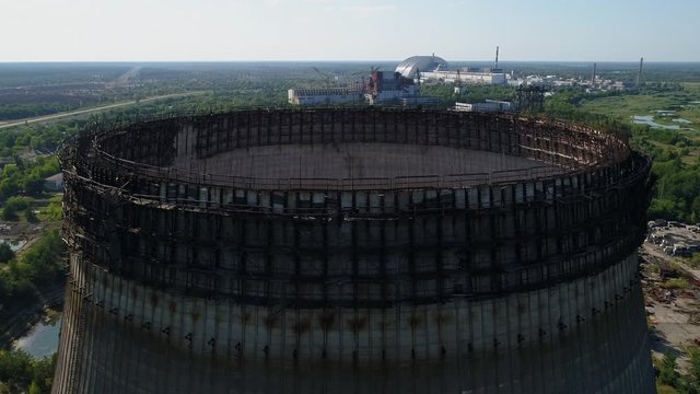 Aerial view of the top of unfinished cooling tower for the fifth and sixth nuclear reactors of third stage of Chernobyl nuclear power plant. Exclusion Zone. 4K drone footage