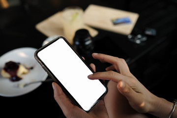 Close up of woman using cell phone,sending massages on the coffee shop.having sunbath.Phone with black screen,texting,video calls,