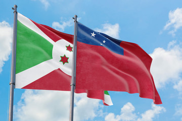 Samoa and Burundi flags waving in the wind against white cloudy blue sky together. Diplomacy concept, international relations.