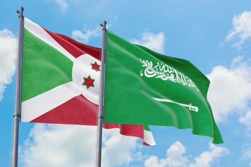 Saudi Arabia and Burundi flags waving in the wind against white cloudy blue sky together. Diplomacy concept, international relations.