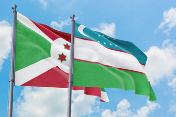 Uzbekistan and Burundi flags waving in the wind against white cloudy blue sky together. Diplomacy concept, international relations.