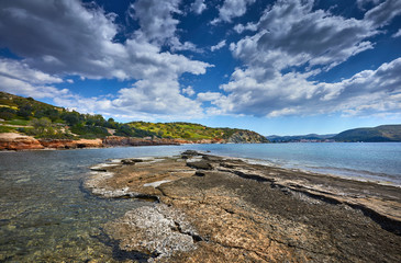 Fishing boats in the morning light. Sunrise on Nuevo Loca Beach. Traveling concept background. Palaia Fokaia location. Greece, Europe. Sunny morning seascape. Spring on the Greek coast Aegean sea