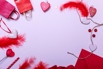 Valentine's Day. Frame made of gifts, candles, confetti on white background. Valentines day background. Flat lay, top view, copy space.