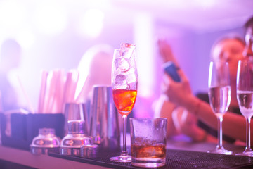 Alcohol drinks nad cocktails at counter in night club