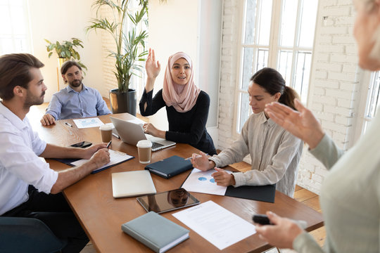 Motivated Arabic female employee participate in group discussion