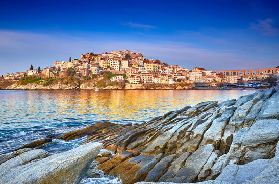 Incredibly romantic sunny spring seascape on Aegean Sea. Colorful morning view of Kavala city, eastern Macedonia, Greece, Europe..Beach view in Greece. Beautiful Kavala's view.