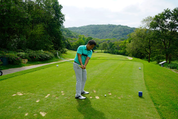 Blurred golfer playing golf in beautiful golf course in the evening golf course with sunshine in...