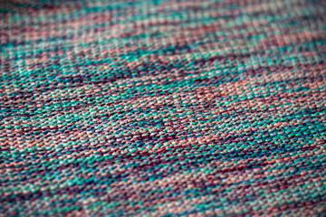 Fototapeta premium Texture of flat vibrant colorful knitted sweater fabric selective focus