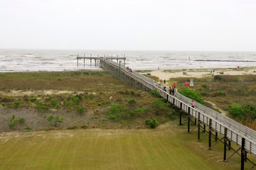 Louisiana nature background. Way to the beach and pier along wooden boardwalk over the sand dunes...