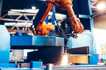 Robotic arm in a factory at work. Heavy industry, machine learning