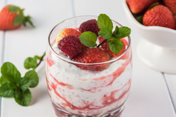 Chia pudding with strawberry sauce and berries.