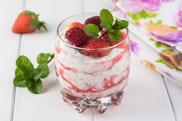 Chia pudding with strawberry sauce and berries.