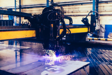 Flame cutting process with steel profiling machine in a factory