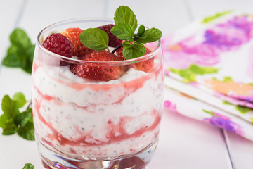 Chia pudding with strawberry sauce and berries.