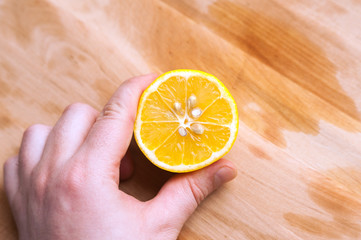 cut lemon in hand
