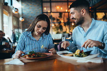 romantic couple in restaurant having lunch