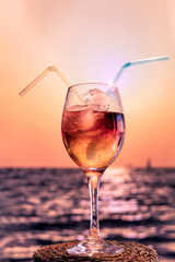refreshing cocktail on the beach during a sunset in summer