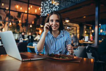 busy woman in restaurant having lunch