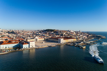 Fototapeta na wymiar Aerial view of the skyline of the city of Lisbon with the Comercio Square, the Alfama Neighbourhood and the Tagus River, in Portugal