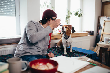 freelancer young man in his workplace with his dog
