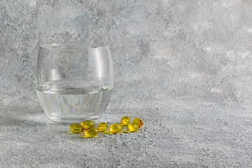 Medicine tablets and glass of water on grey background. Medicine concept of respiratory disease treatment. Disease spread prevention