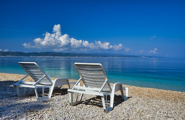 Amazing seascape of Adriatic sea. Colorful summer view of small Brela beach Croatia, Europe. Croatian coast with clear water and pine trees around. Tropical viewpoint for design postcard.
