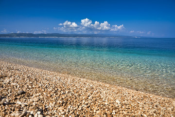 Amazing seascape of Adriatic sea. Colorful summer view of small Brela beach Croatia, Europe. Croatian coast with clear water and pine trees around. Tropical viewpoint for design postcard.