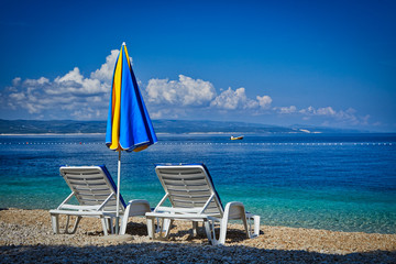 Amazing seascape of Adriatic sea. Colorful summer view of small Brela beach Croatia, Europe. Croatian coast with clear water and pine trees around. Tropical viewpoint for design postcard.