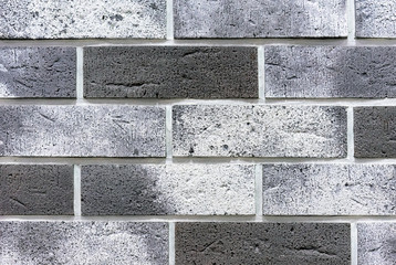 Brick wall from of gray and white bricks. Background and texture of brickwork.