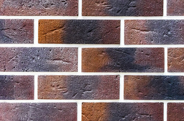 Brick wall of beige and brown bricks. Background and texture of brickwork.