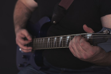 Fototapeta premium the guy plays the electric guitar