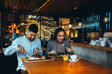 romantic couple eating in restaurant