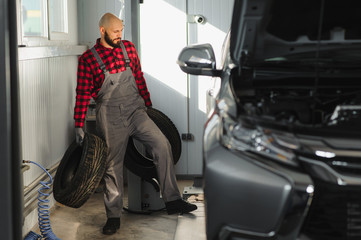 Man repairing a car wheel in a garage