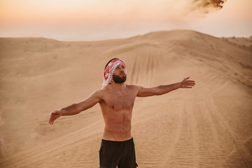 Young handsome man portrait on the desert