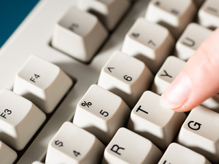 Female forefinger pushes T button. Close-up
