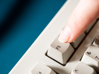 Female forefinger pushes F5 button. Close-up