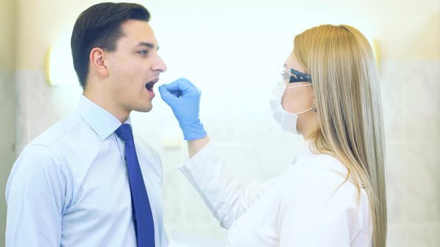 Laboratory worker performing DNA paternity test in a medical laboratory. Implementation of DNA sampling in humans