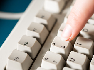 Female forefinger pushes 8 button. Close-up