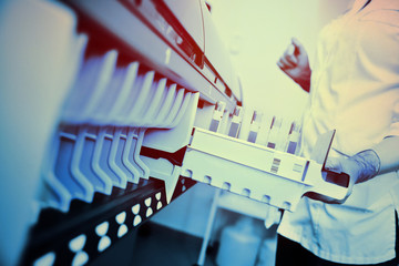 a female scientist near the analyzer in a medical microbiological laboratory. Equipment for analysis, DNA, PCR.2019-nCoV; coronavirus; China;
