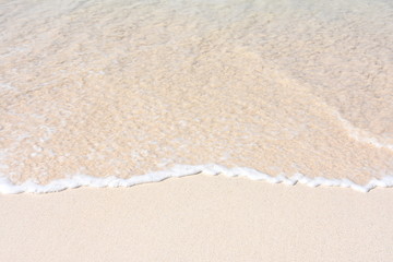 Fototapeta na wymiar Wave on a sandy beach