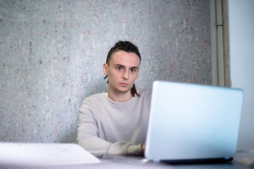 One young men is looking at computer